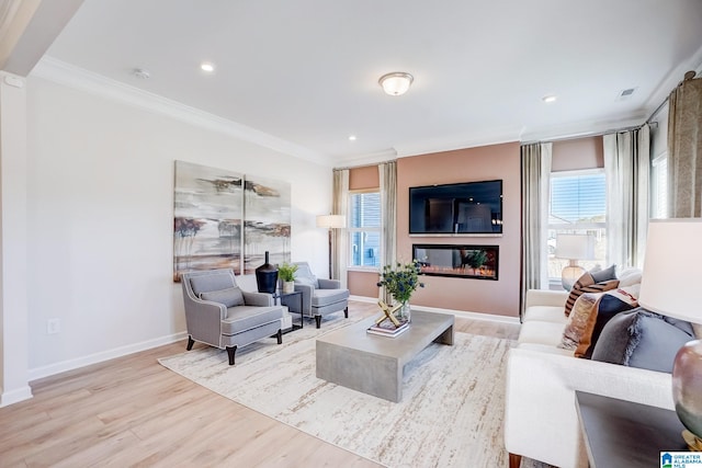 living room with light hardwood / wood-style flooring, plenty of natural light, and crown molding