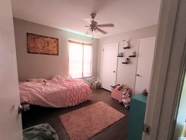 bedroom featuring dark hardwood / wood-style flooring and ceiling fan