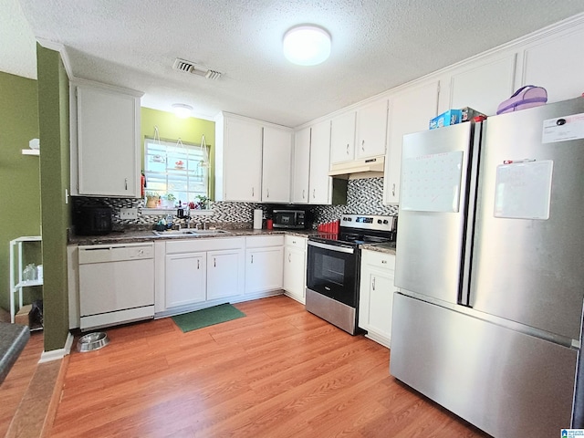 kitchen featuring stainless steel appliances, sink, light wood-type flooring, and white cabinets