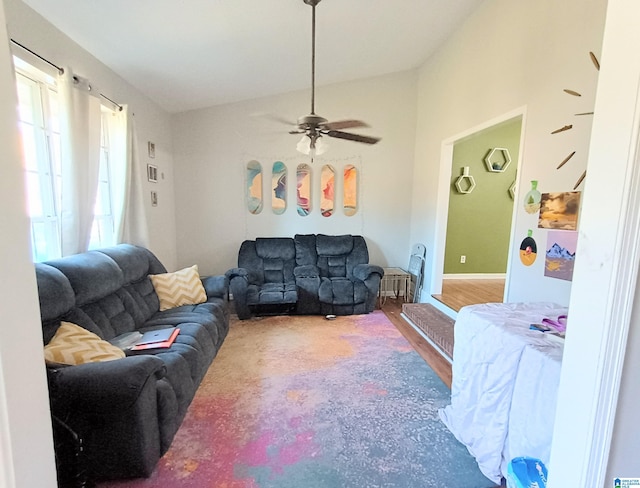 living room with hardwood / wood-style floors, vaulted ceiling, and ceiling fan