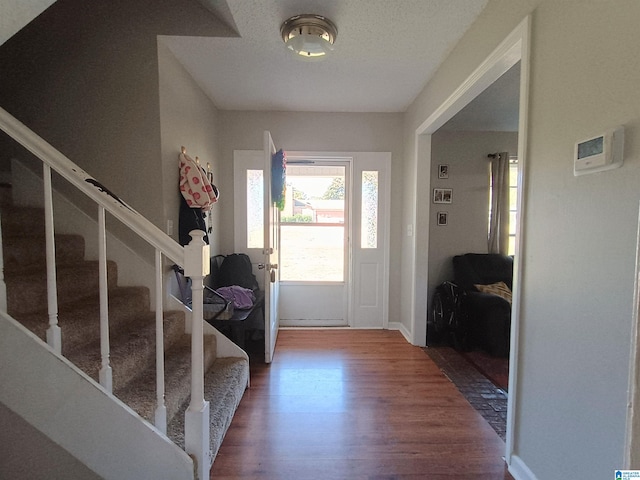 entryway featuring hardwood / wood-style floors and a textured ceiling