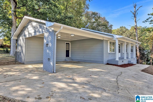 ranch-style house featuring a carport