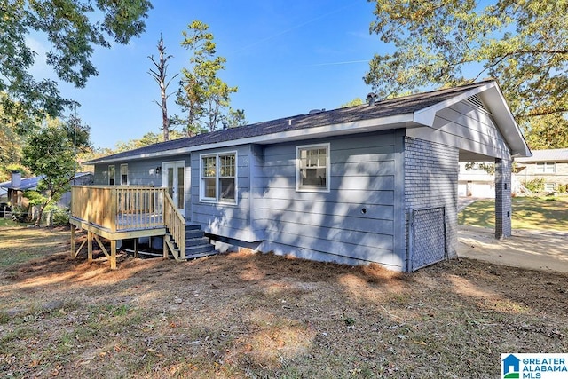 view of front of property with a wooden deck and a garage