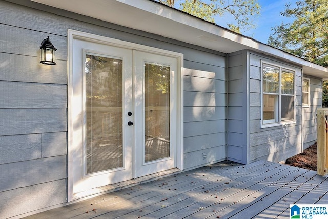 view of exterior entry featuring a wooden deck