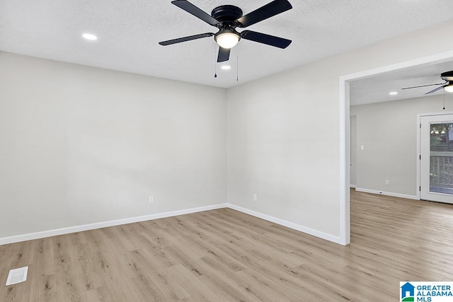 unfurnished room featuring light hardwood / wood-style floors, a textured ceiling, and ceiling fan