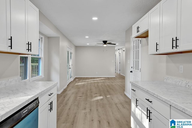 kitchen with white cabinetry, light stone counters, dishwasher, and light wood-type flooring