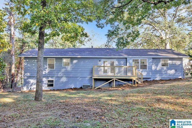 back of house featuring a deck, a lawn, and cooling unit