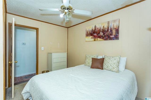 bedroom featuring ornamental molding, a textured ceiling, ceiling fan, and carpet floors