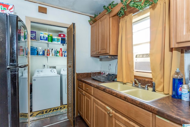 clothes washing area with washer and clothes dryer and sink