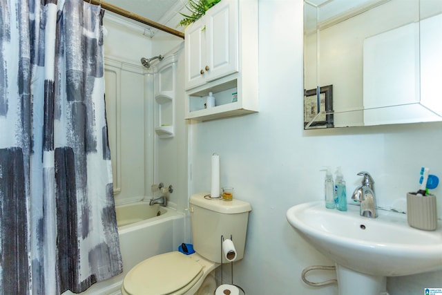 full bathroom with shower / bath combo with shower curtain, sink, and toilet