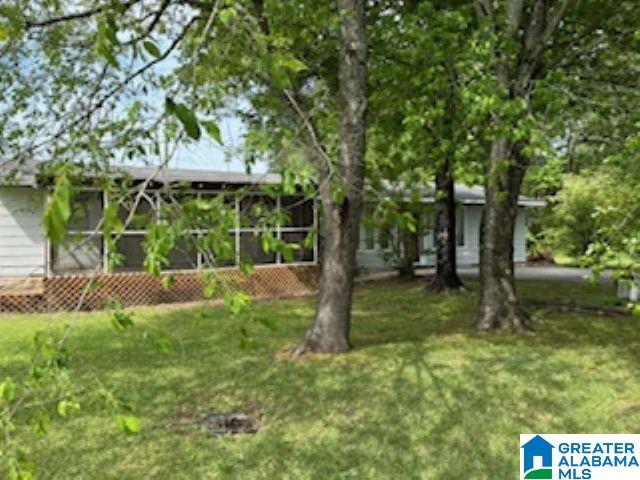405 Depot St, Columbiana, AL 35051 - view of grassy yard featuring a sunroom