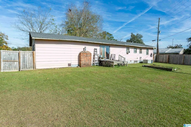 rear view of property featuring a yard