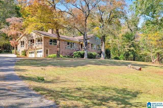 1215 Red Valley Rd, Remlap, AL 35133 - view of front of property featuring an attached garage, asphalt driveway, a front yard, and a chimney