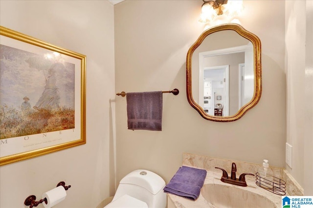 bathroom featuring vanity and toilet