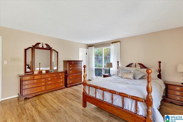 bedroom featuring hardwood / wood-style floors and a textured ceiling