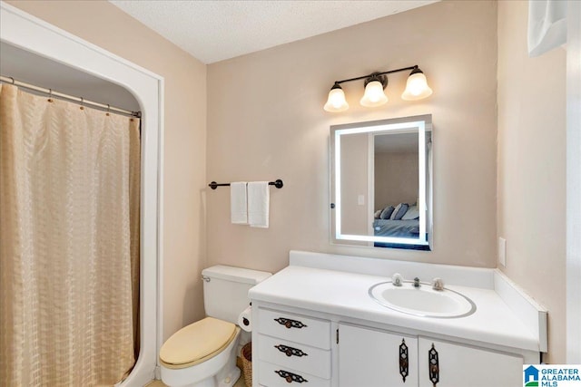 bathroom with vanity, toilet, a textured ceiling, and a shower with shower curtain