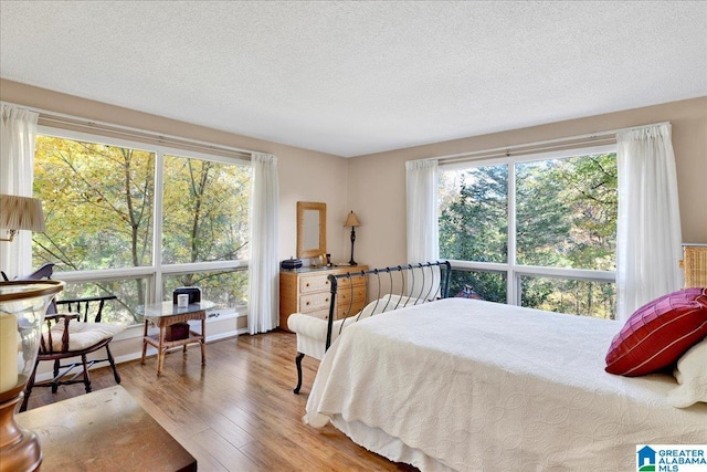 1215 Red Valley Rd, Remlap, AL 35133 - bedroom with wood finished floors and a textured ceiling