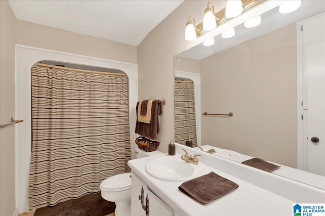 bathroom featuring vanity, toilet, a textured ceiling, and walk in shower