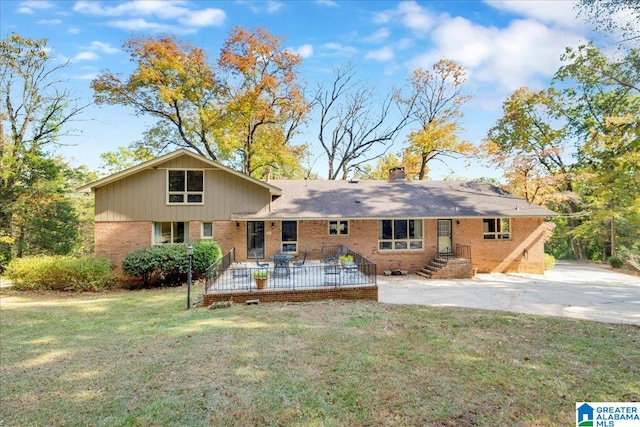 exterior space with a front yard and a wooden deck