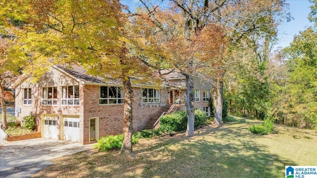 view of front of property with a front lawn and a garage