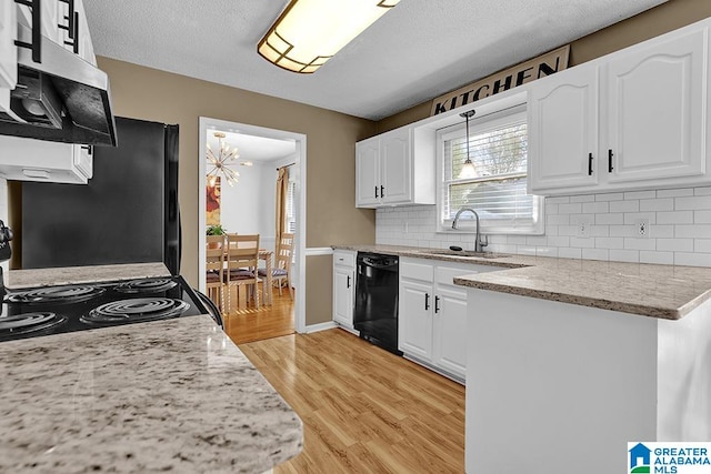 kitchen with decorative backsplash, light hardwood / wood-style flooring, sink, black appliances, and white cabinets