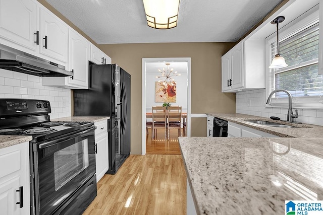 kitchen with light hardwood / wood-style flooring, black appliances, sink, and white cabinets