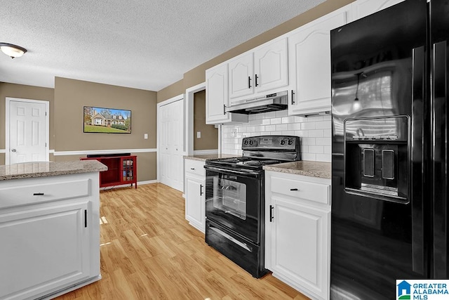 kitchen featuring tasteful backsplash, black appliances, a textured ceiling, white cabinetry, and light hardwood / wood-style flooring