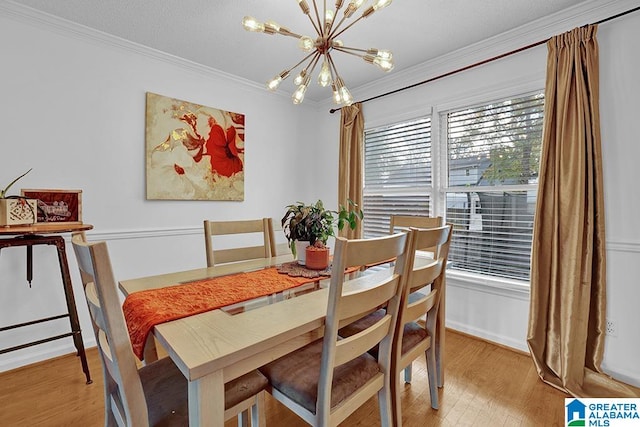 dining space featuring crown molding, a notable chandelier, and wood-type flooring