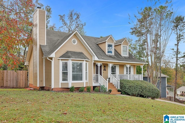 cape cod home featuring a front lawn and a porch