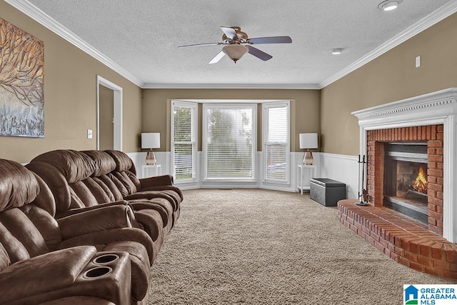 carpeted living room featuring ceiling fan, a textured ceiling, ornamental molding, and a fireplace