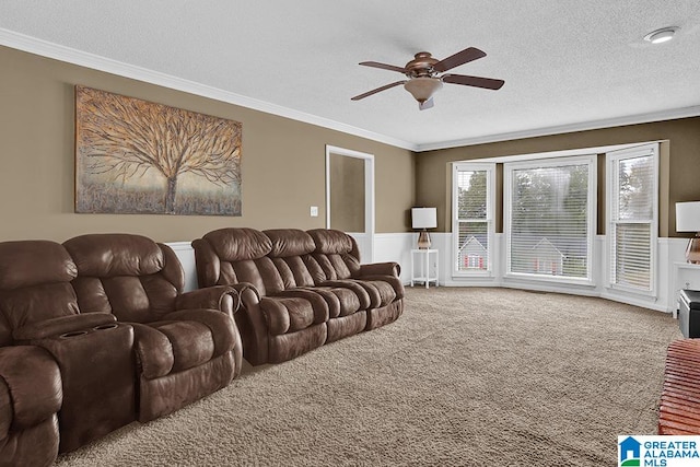 living room featuring carpet, crown molding, a textured ceiling, and ceiling fan