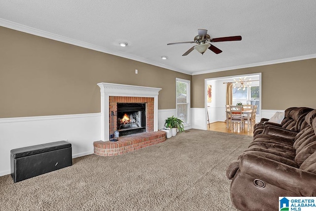 carpeted living room with crown molding, a brick fireplace, and a textured ceiling