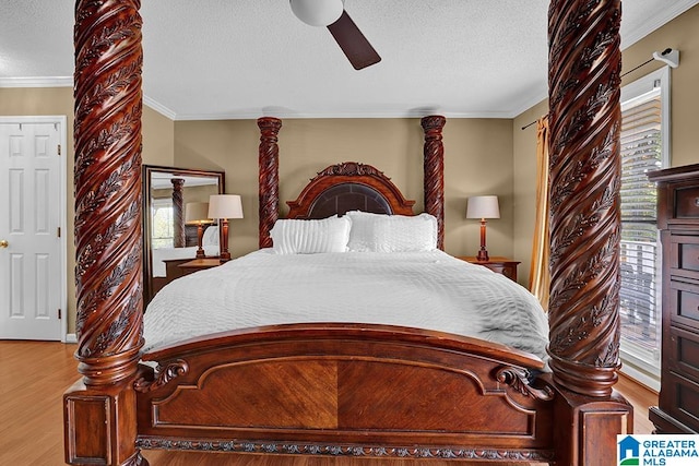 bedroom featuring crown molding, multiple windows, and light wood-type flooring