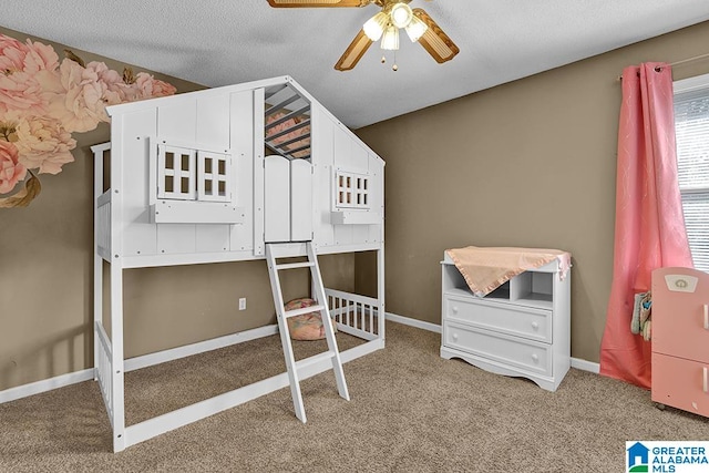 carpeted bedroom featuring a textured ceiling and ceiling fan