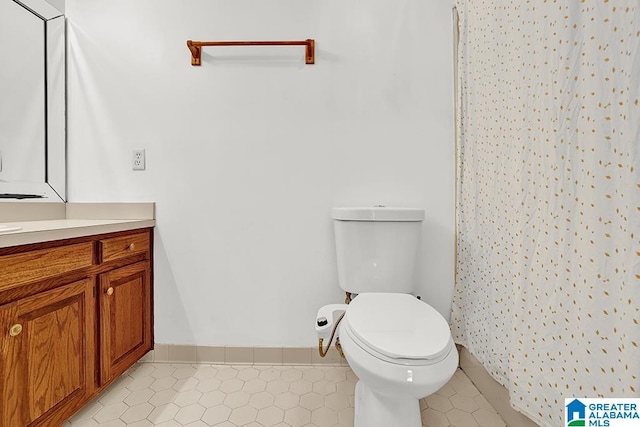 bathroom with vanity, toilet, and tile patterned floors