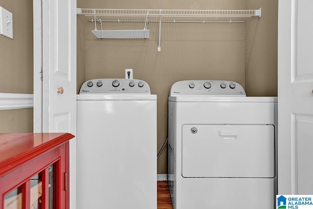 laundry room featuring washer and clothes dryer and wood-type flooring