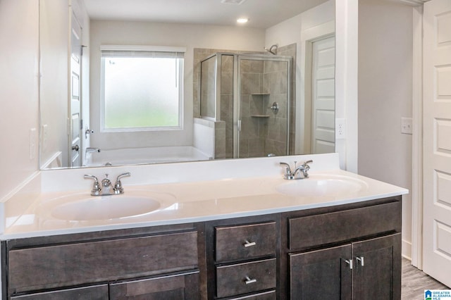 bathroom featuring vanity, plus walk in shower, and hardwood / wood-style flooring