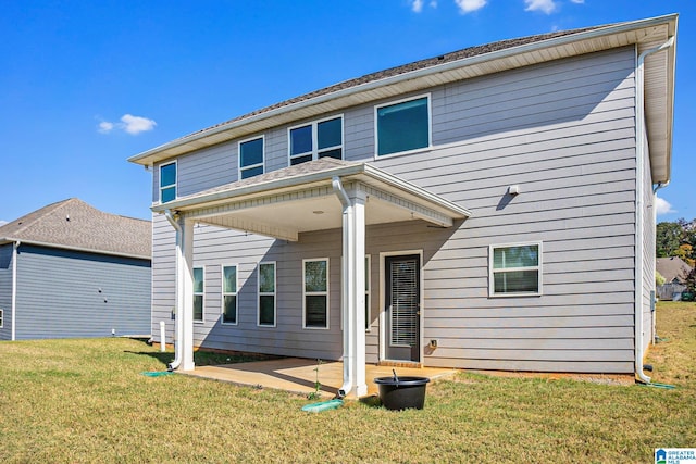 back of property featuring a yard and a patio area