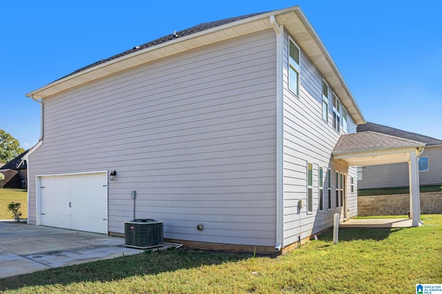 view of side of property with a yard and central air condition unit