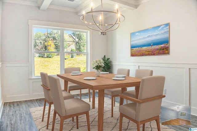 dining area with a notable chandelier, beamed ceiling, and hardwood / wood-style floors