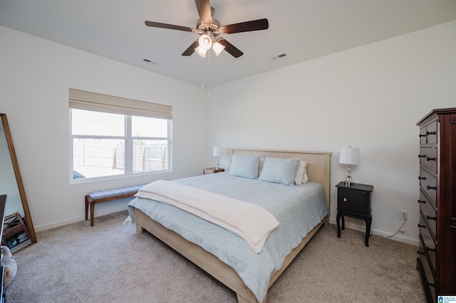 bedroom featuring light colored carpet and ceiling fan