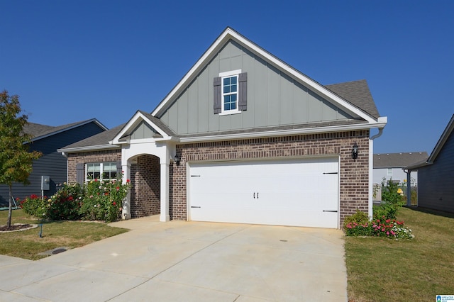 view of front of home with a front lawn and a garage