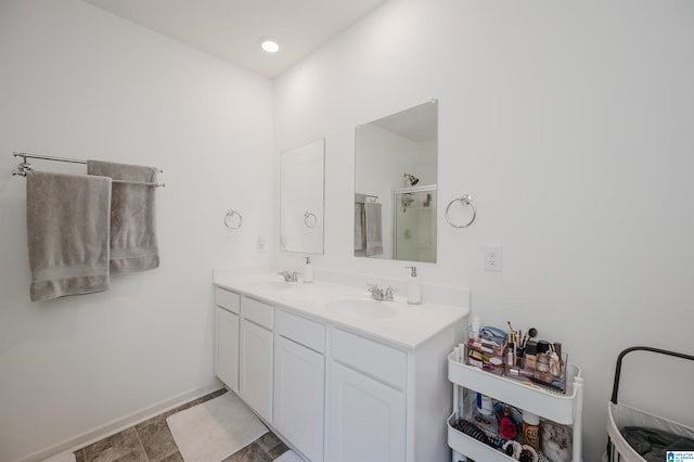 bathroom featuring vanity and a shower with shower door