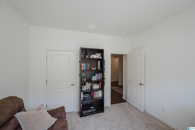 sitting room featuring light carpet