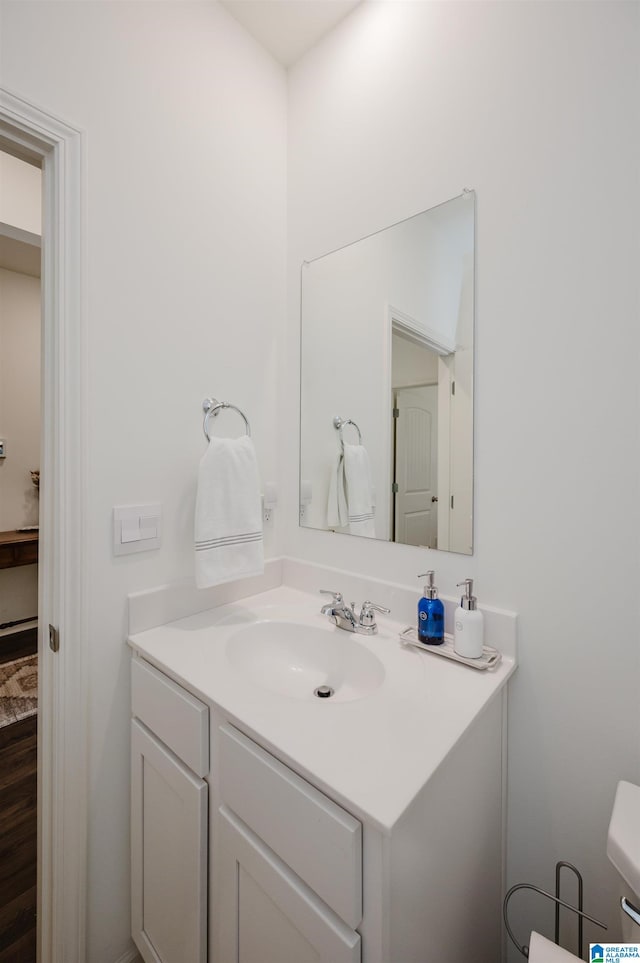 bathroom featuring vanity and toilet