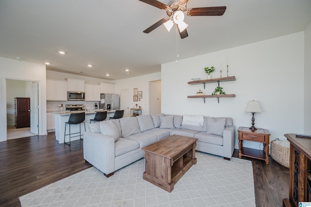 living room with light hardwood / wood-style floors and ceiling fan