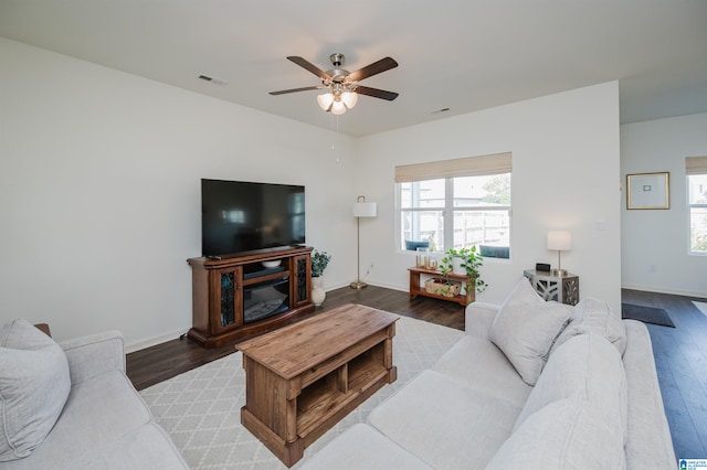 living room with wood-type flooring and ceiling fan