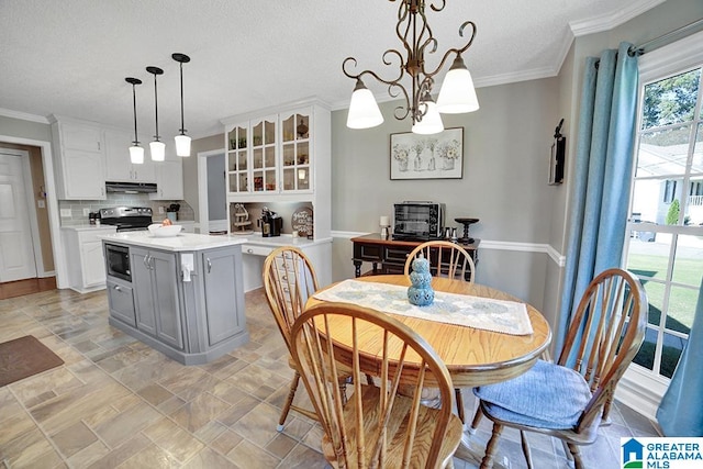 kitchen featuring pendant lighting, built in microwave, tasteful backsplash, white cabinets, and electric range