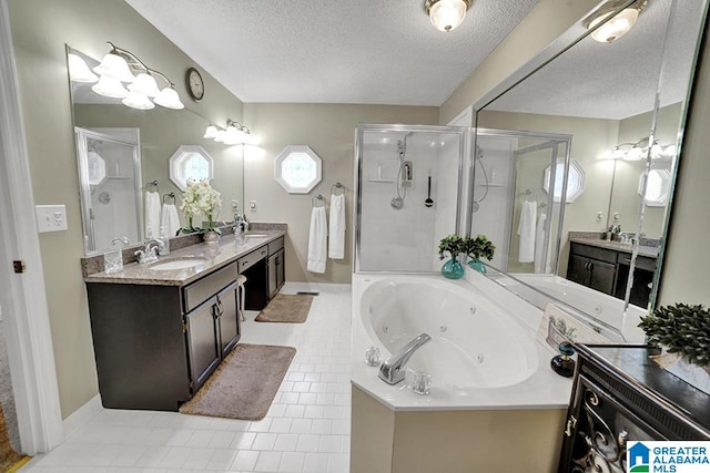 bathroom featuring vanity, a textured ceiling, separate shower and tub, and tile patterned flooring