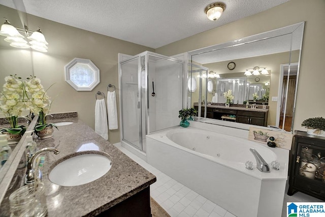 bathroom featuring vanity, a textured ceiling, independent shower and bath, and tile patterned flooring